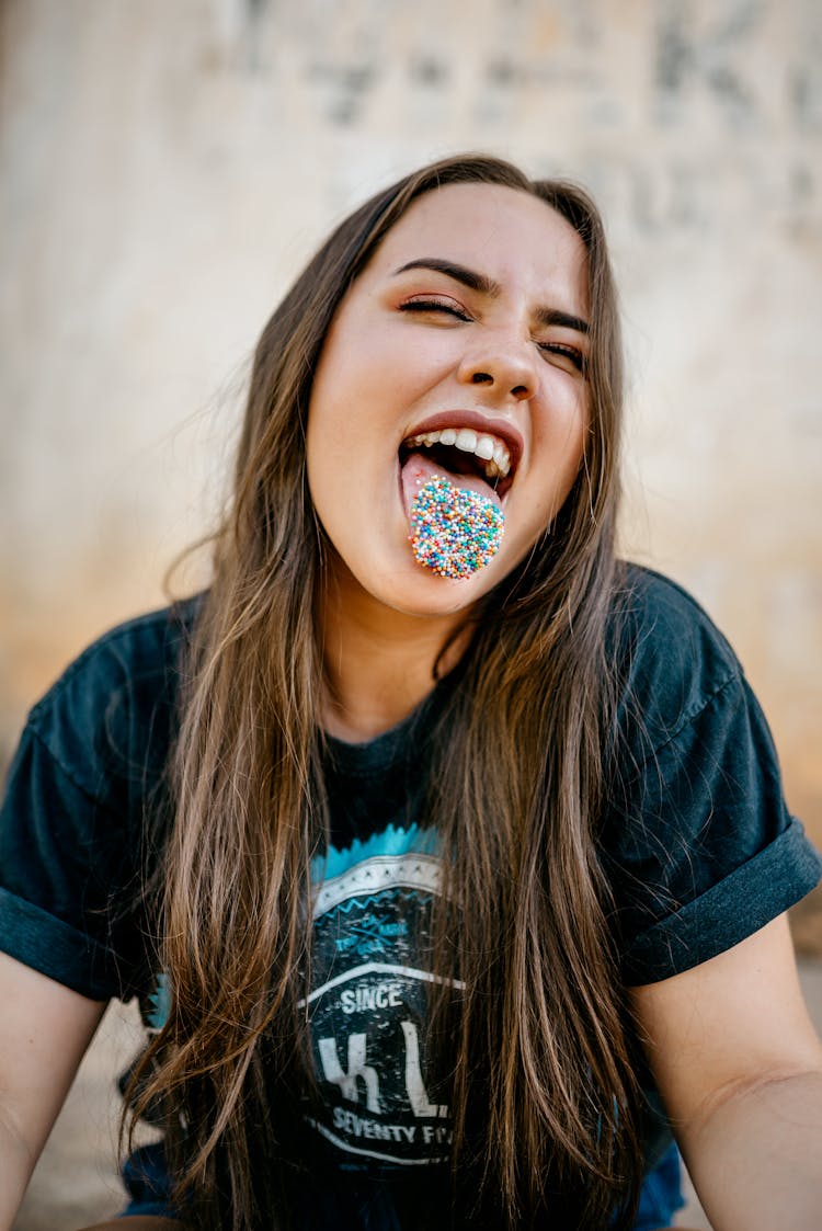 Woman With Candies On Tongue