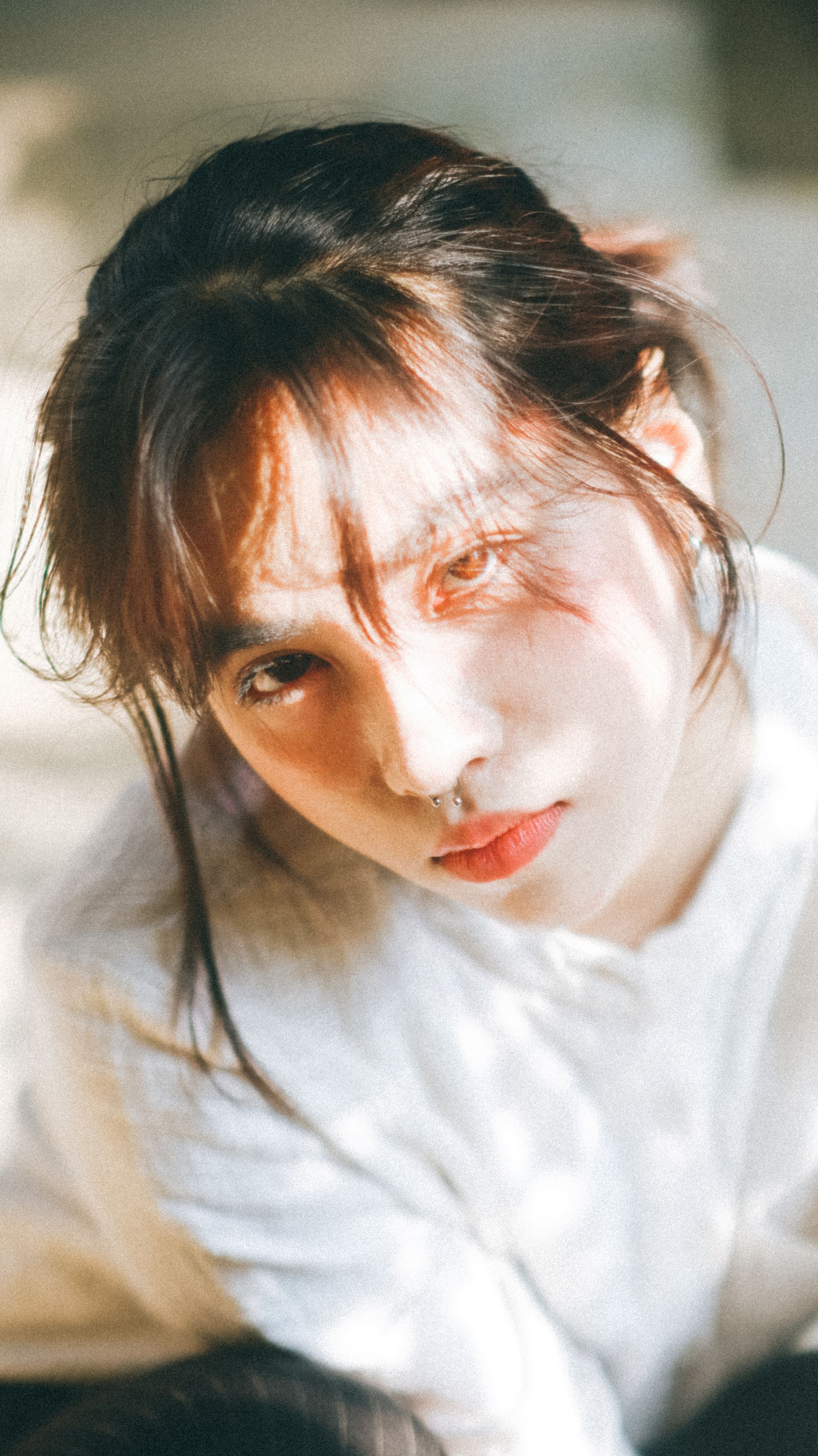 young woman sitting in sunlight
