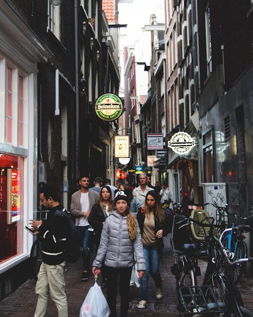 Pedestrians Walking in a Narrow City Street 