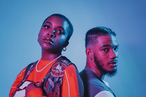 Two Models Posing under Blue and Red Lighting