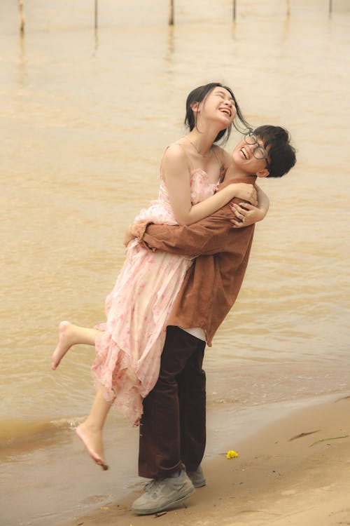 Laughing Young Couple at Beach