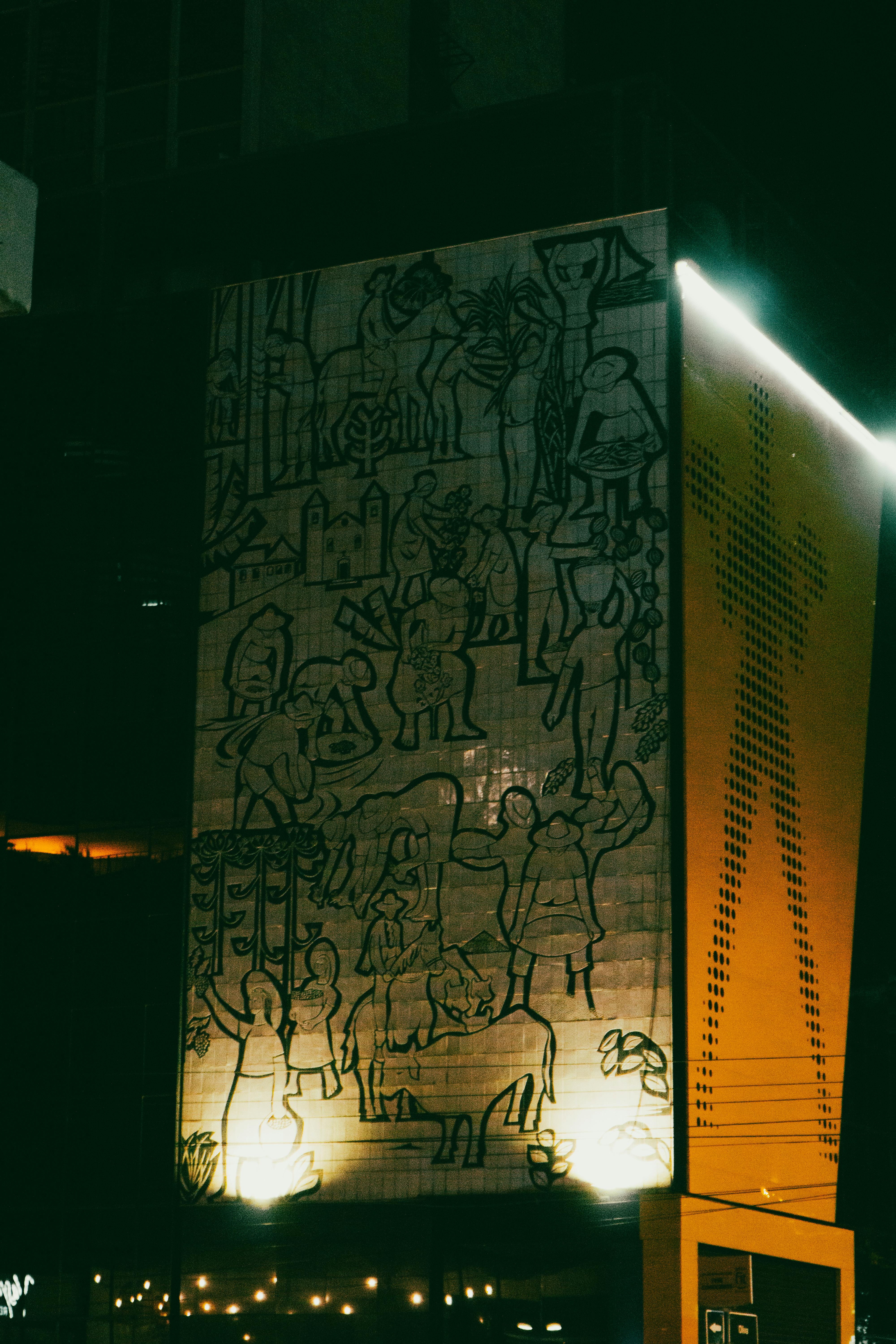 Free A vibrant night view of an illuminated mural on a city facade in Asunción, Paraguay. Stock Photo