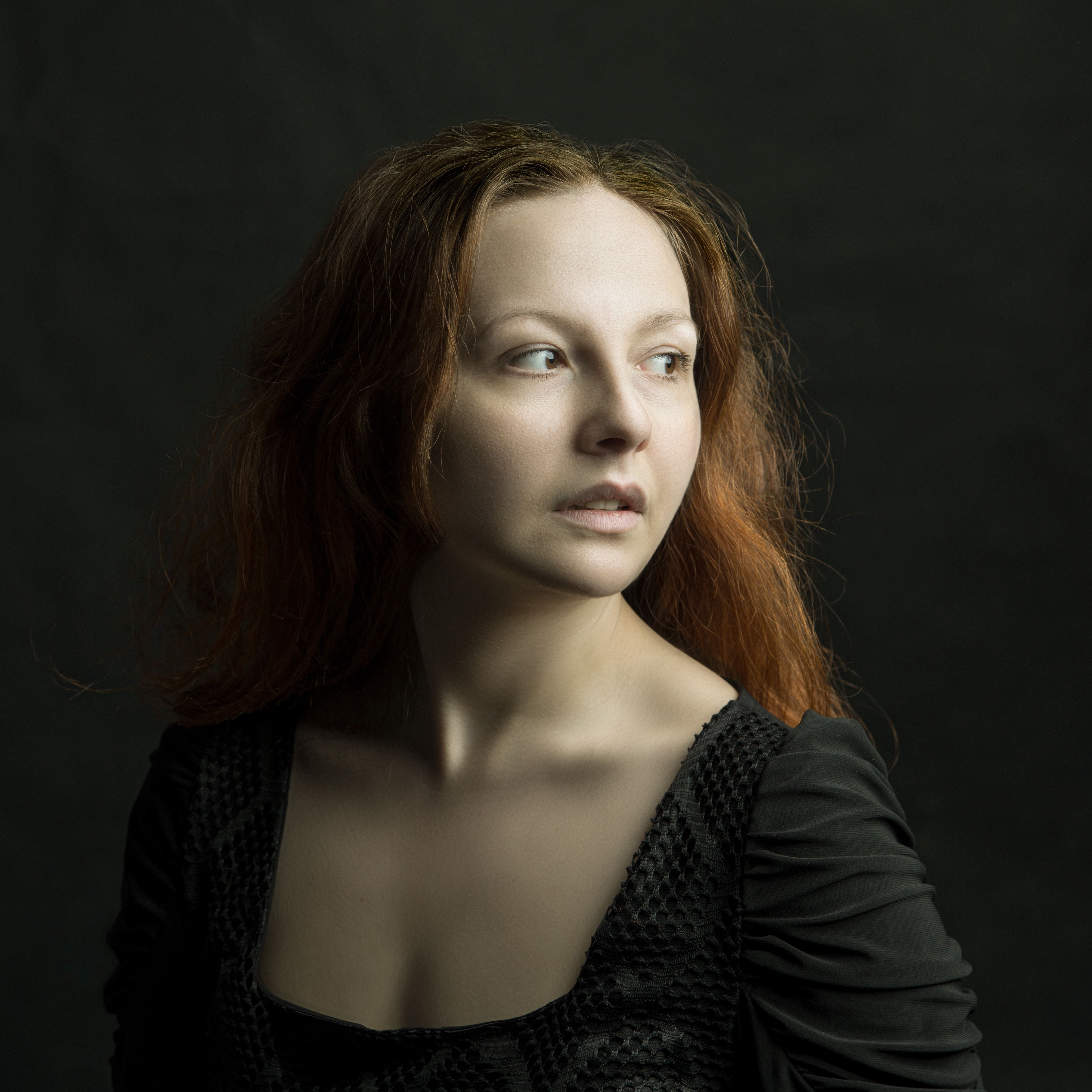 A woman with red hair posing in black · Free Stock Photo