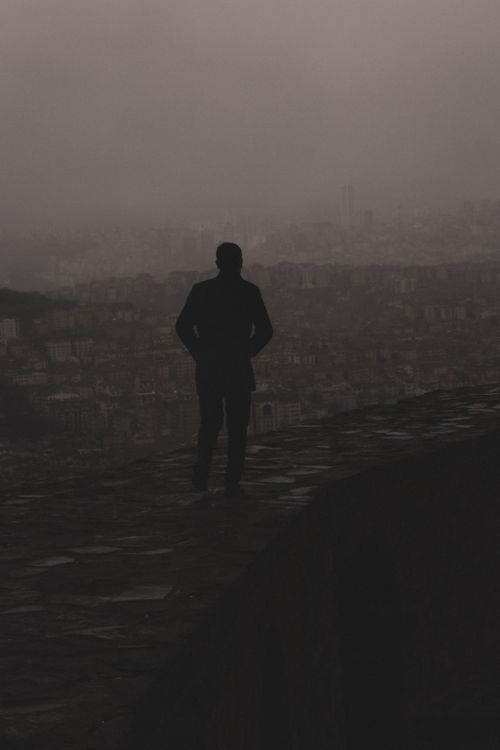 Free A solitary figure silhouetted against the foggy cityscape of Ankara, creating a mysterious and contemplative mood. Stock Photo
