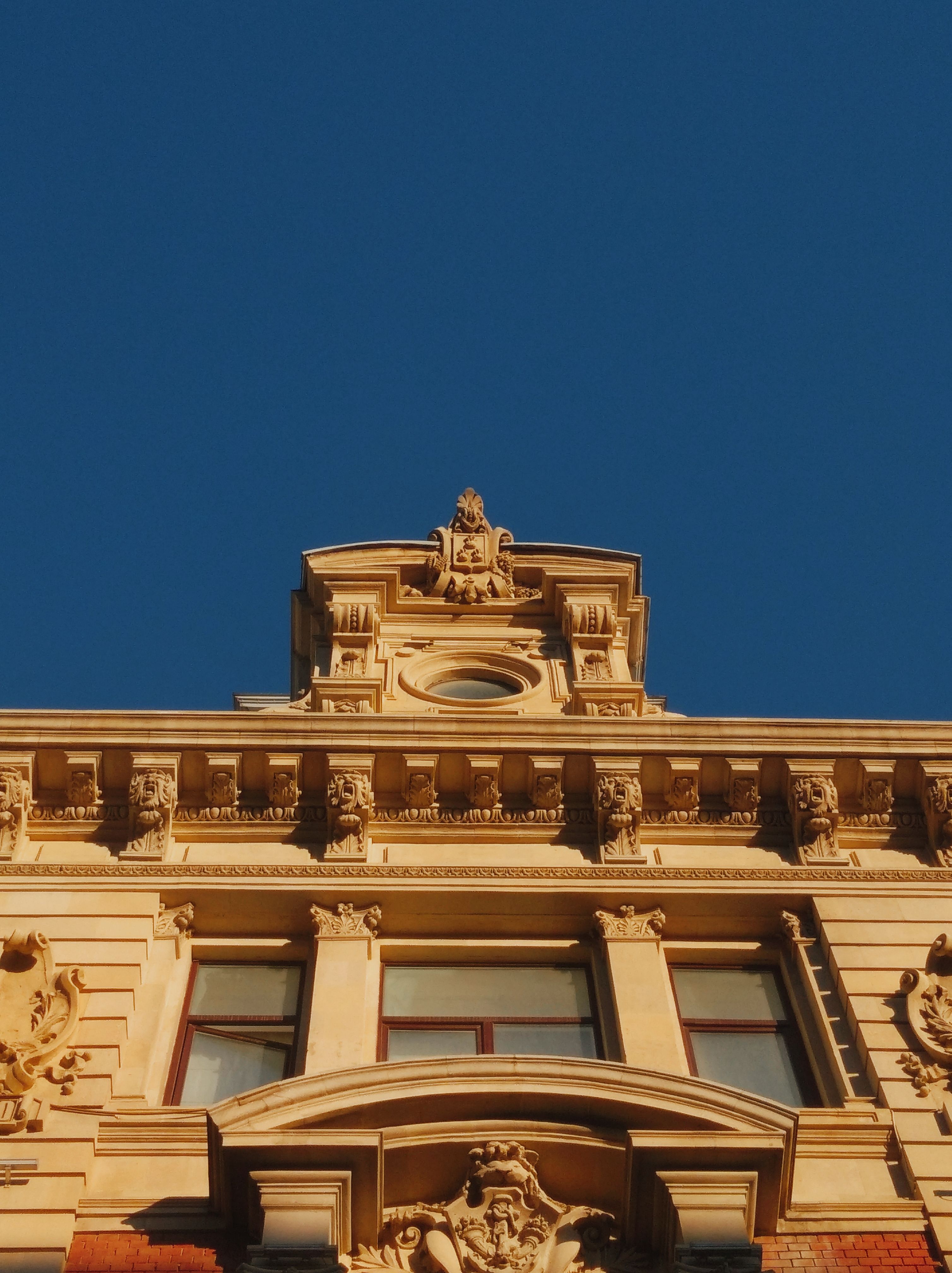 Neoclassical Facade under Blue Sky · Free Stock Photo