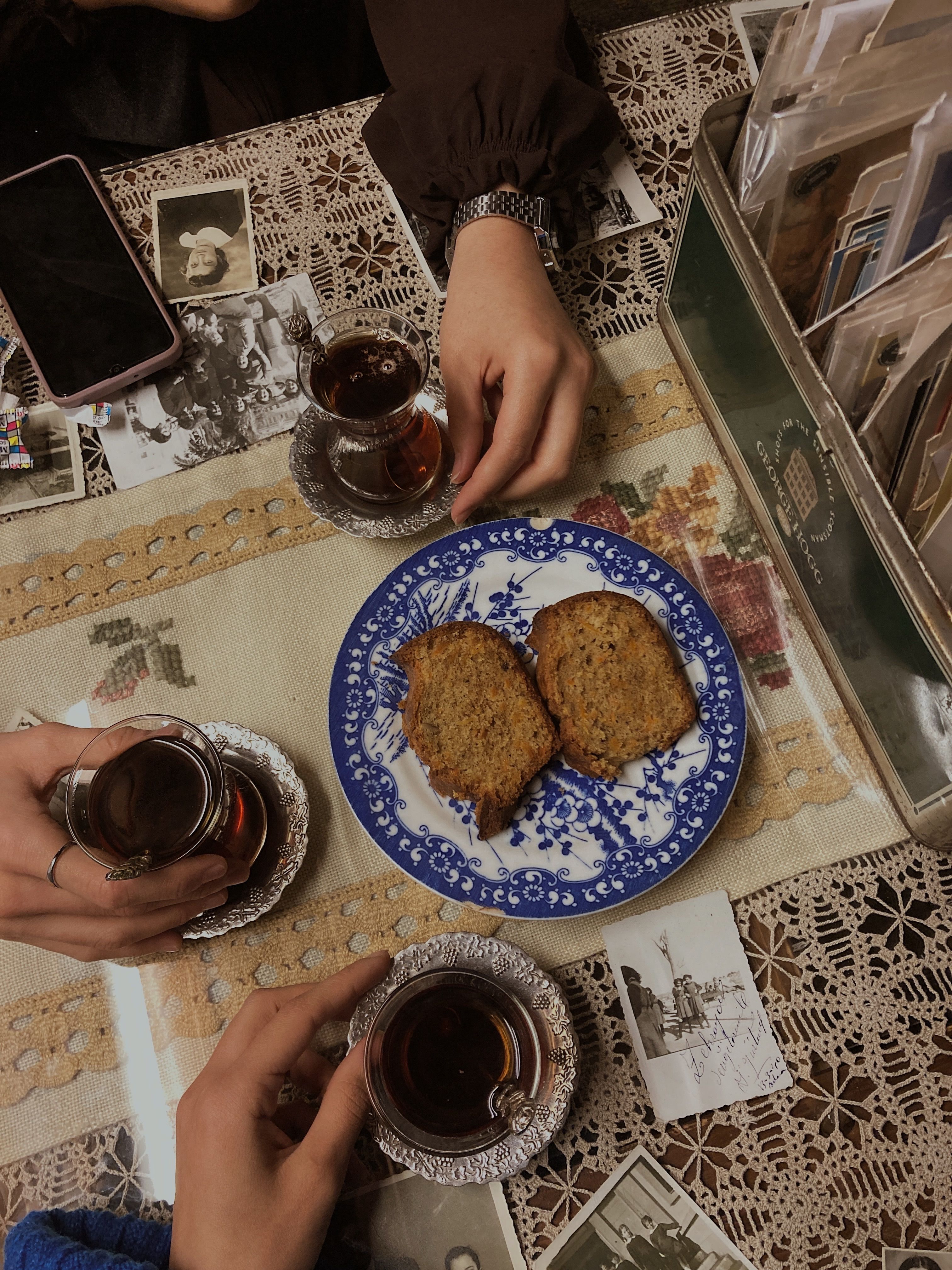 Tea and Snack on Table with Vintage Doilies and Photos · Free Stock Photo