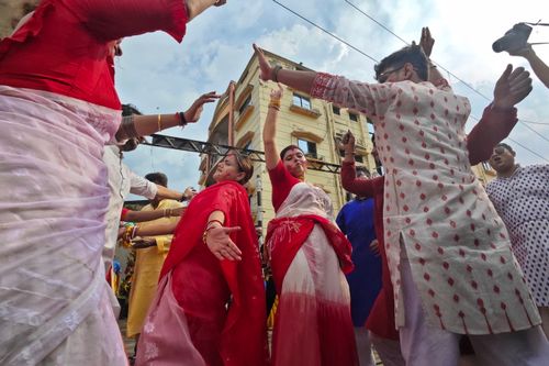 Free People dancing in traditional clothing during a street festival in Kolkata, India. Stock Photo