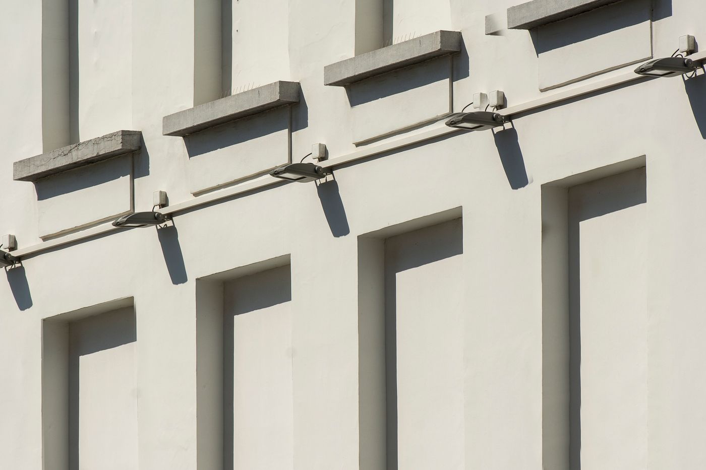 Building facade with sunlit geometric shadows