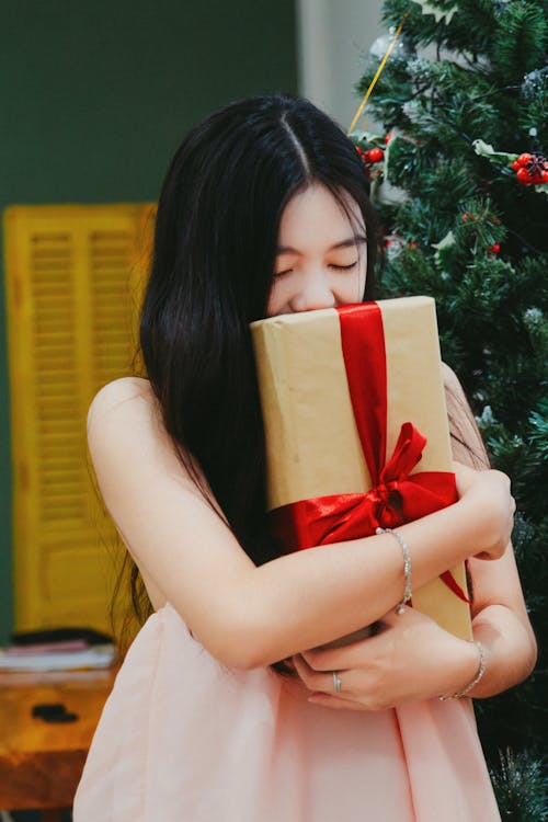 Woman Hugging Christmas Gift