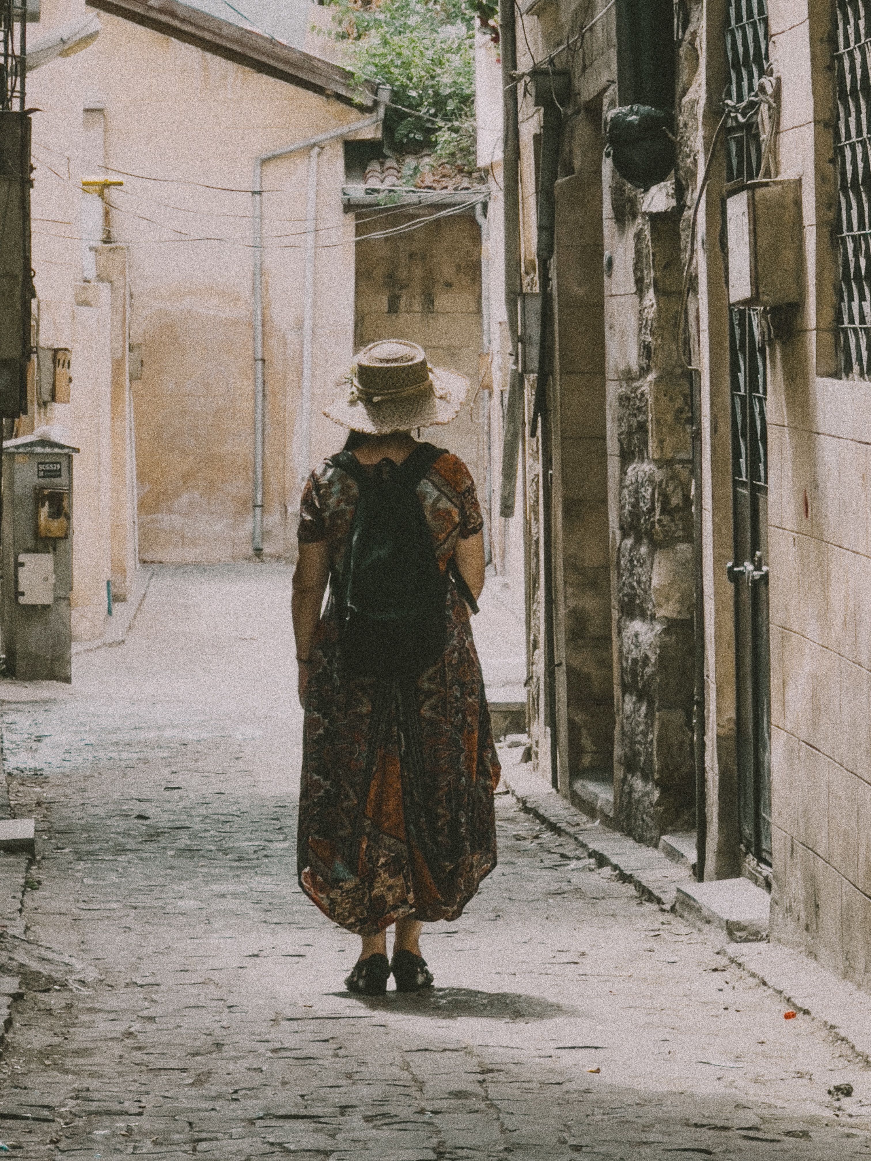 Woman in Dress and Hat on Cobblestone Street in Town · Free Stock Photo