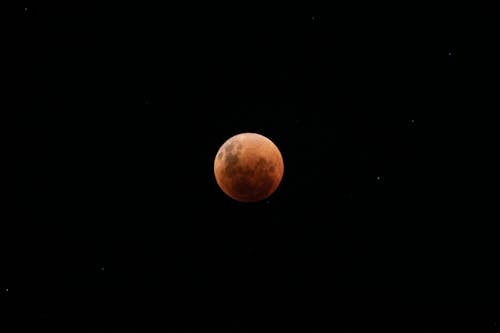 Red Moon and Stars in the Black Night Sky