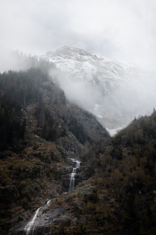 Free A serene scene capturing a misty mountain with a cascading waterfall in Ginzling, Tirol, Austria. Stock Photo