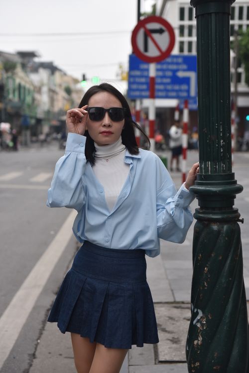 Woman in pleated skirt with fitted top, day to night outfit