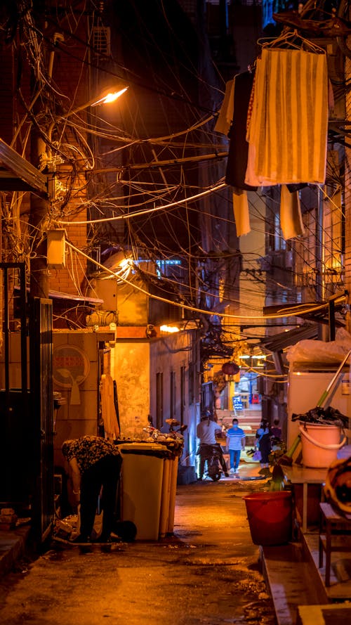 Tangle of Cables Above a Narrow Alley at Night