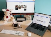 Laptop by Monitor on Desk