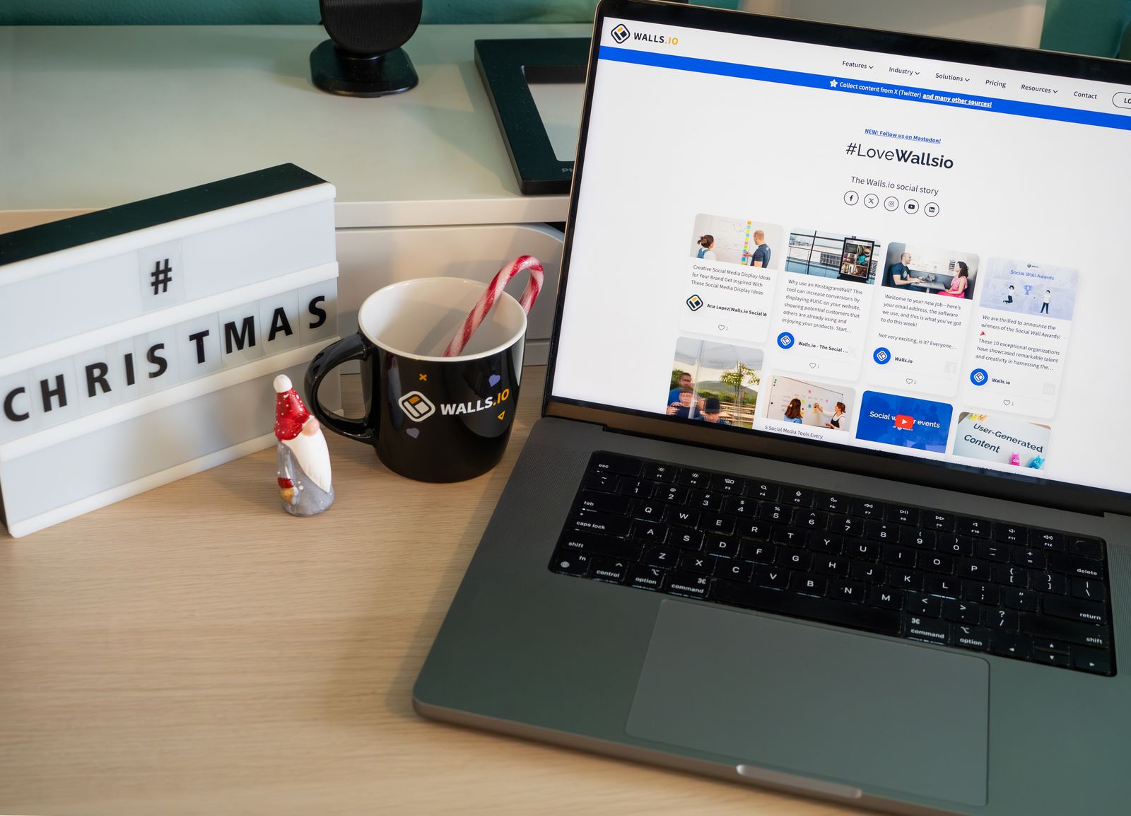 cozy office setup with Christmas decor, mug, and laptop, landscape
