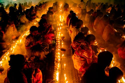 Free A cultural event in Narayanganj, Bangladesh with people gathered around candlelight, creating a warm and spiritual ambiance. Stock Photo