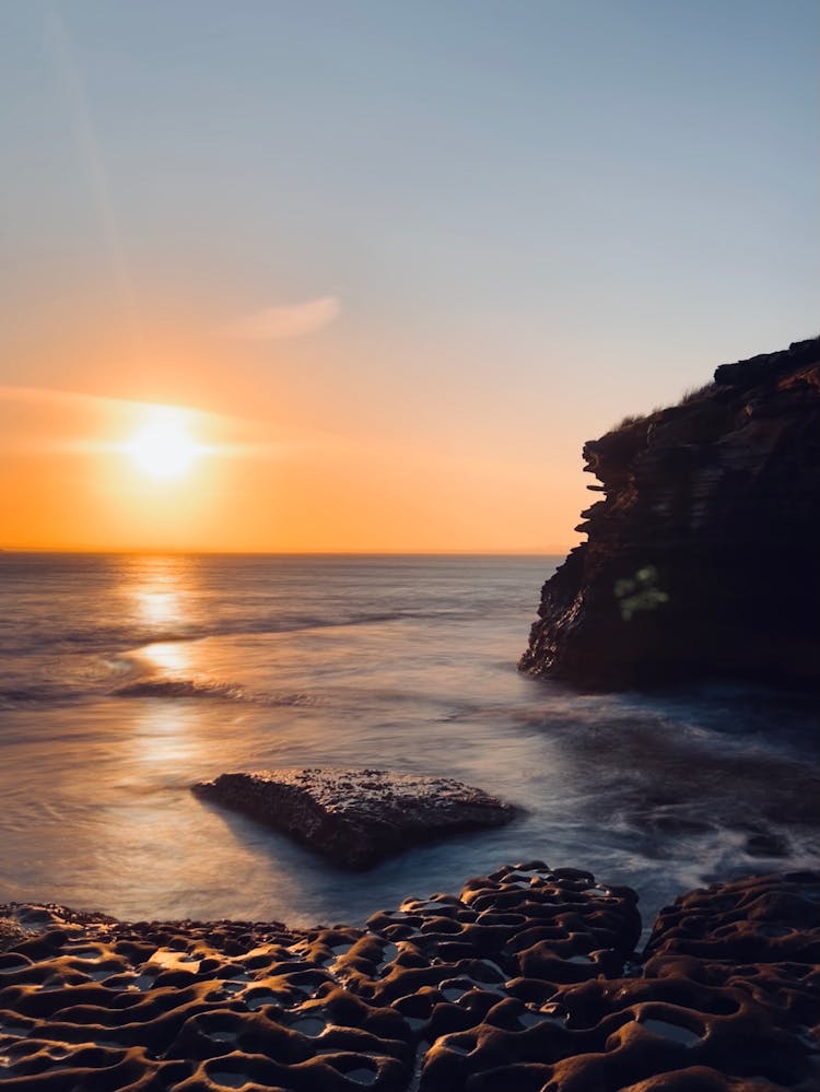 View Of A Seashore At Sunset 