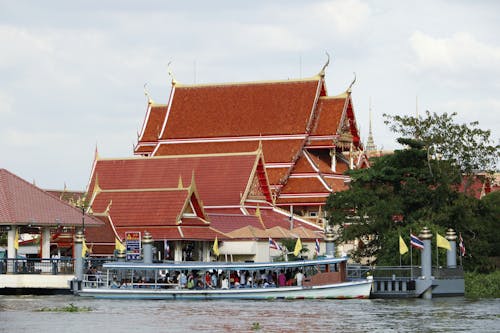 People on Passenger Ship on River near Buddhist Temple