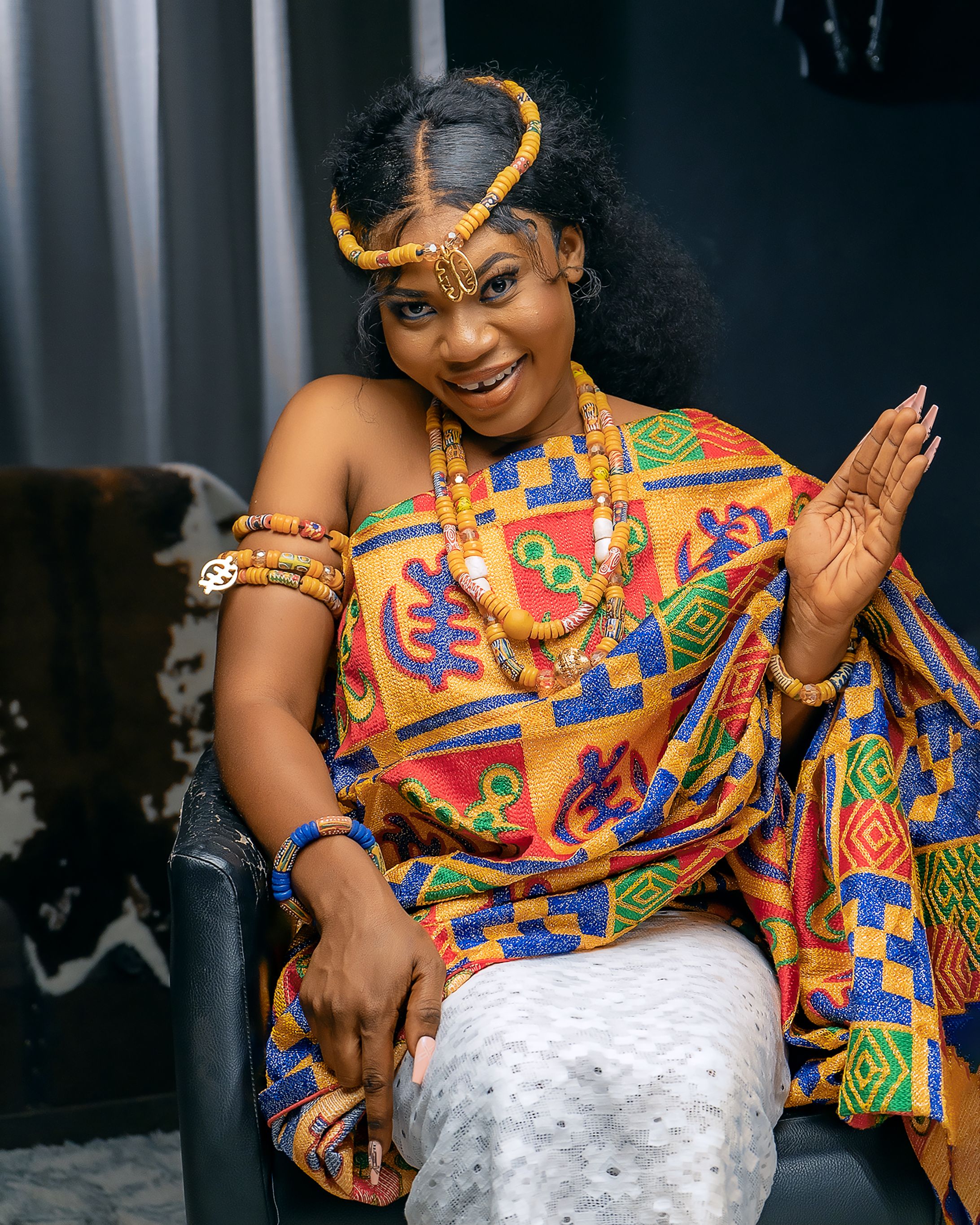 Woman in Traditional Dress Sitting on Sofa · Free Stock Photo