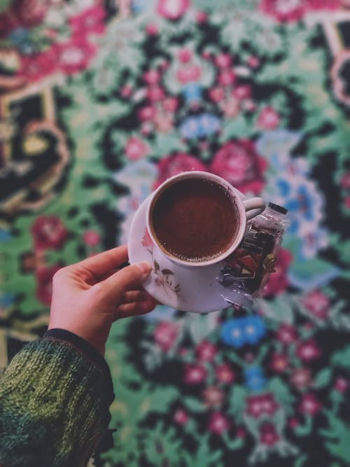 Hand Holding Cup of Coffee