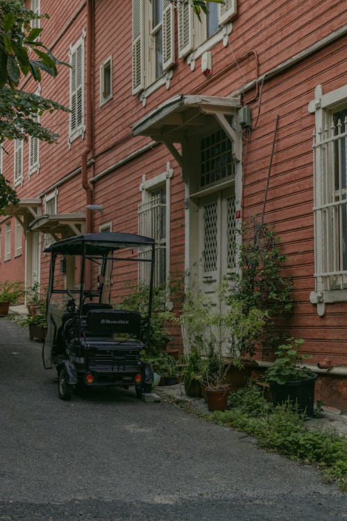 A Cart Parked in front of a Building in City 