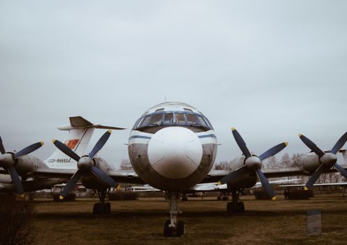 Front view of a vintage Soviet-era propeller airplane outdoors in an open-air museum setting., free online jigsaw puzzle on JigsawPuzzlesFreeOnline.org