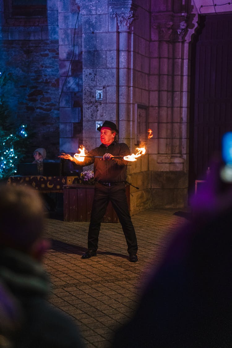 Man Dancing With Fire In Front Of The Audience 