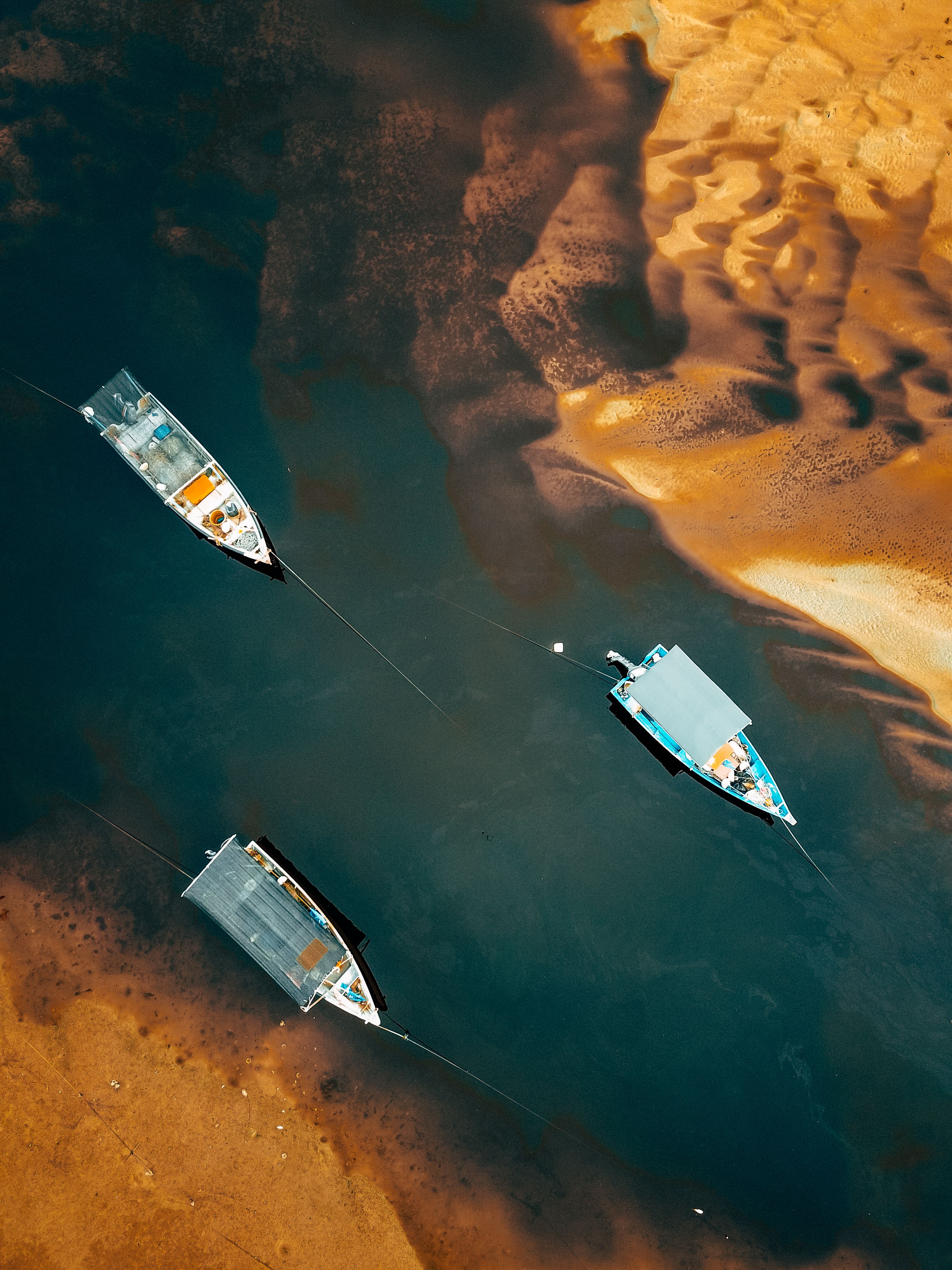 Aerial View of Fishing Boats by a Sandy Shore · Free Stock Photo