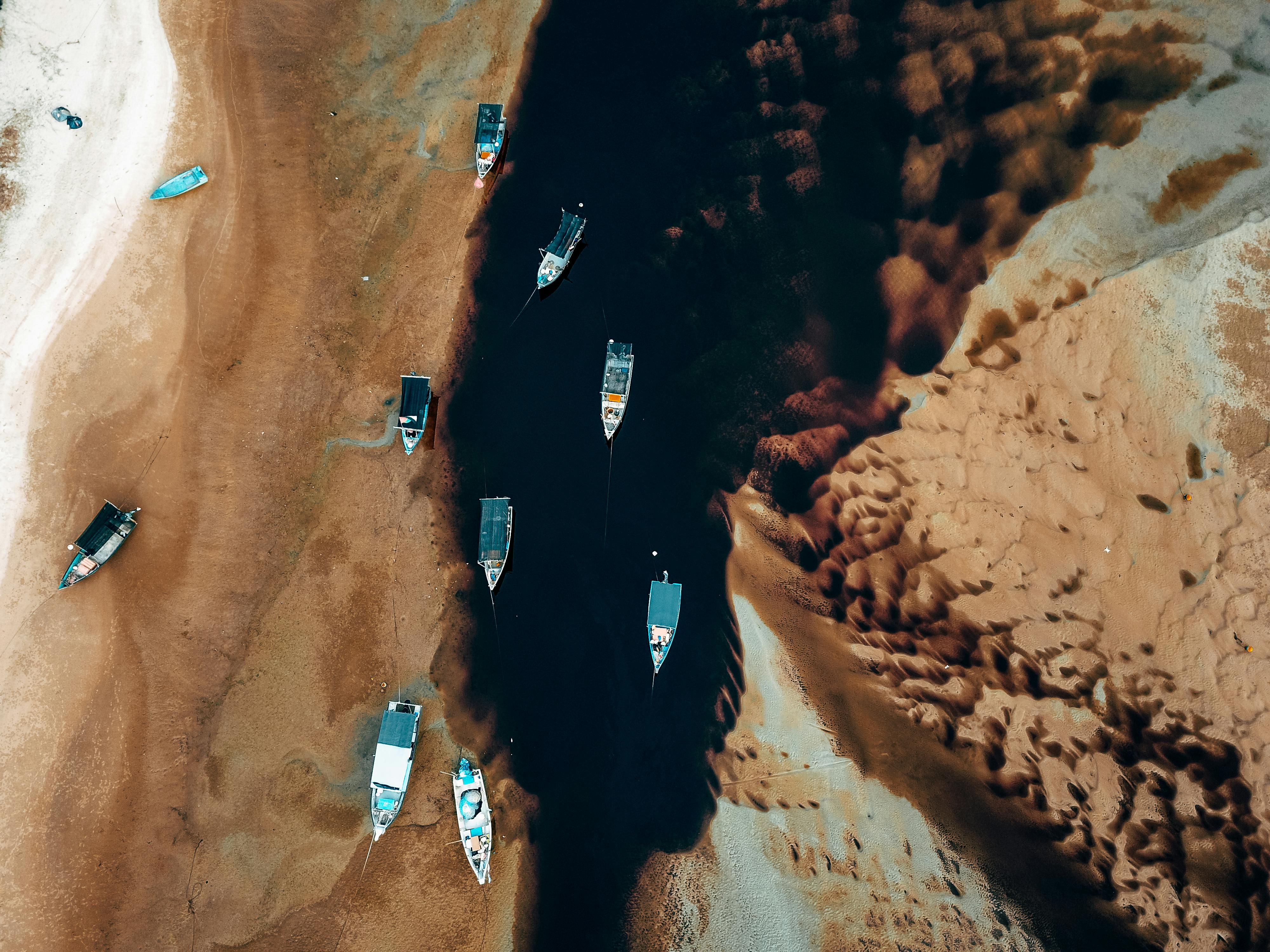 A stunning aerial view of boats anchored along a river in Chukai, Terengganu, Malaysia.