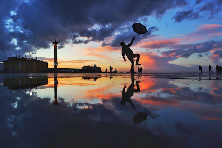 The Sky Reflected In Water At Sunset 