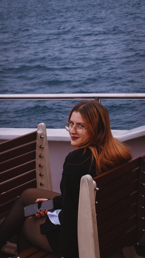 Young Woman Sitting on a Ferry and Looking over the Shoulder 