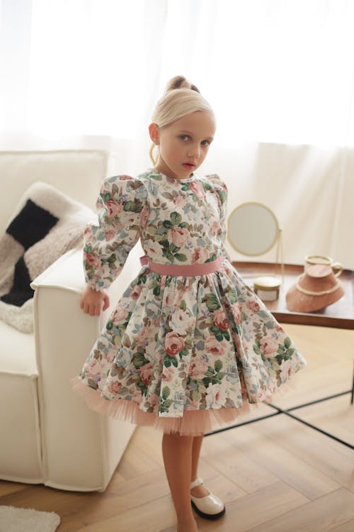 A Little Girl in a Dress with a Floral Pattern 