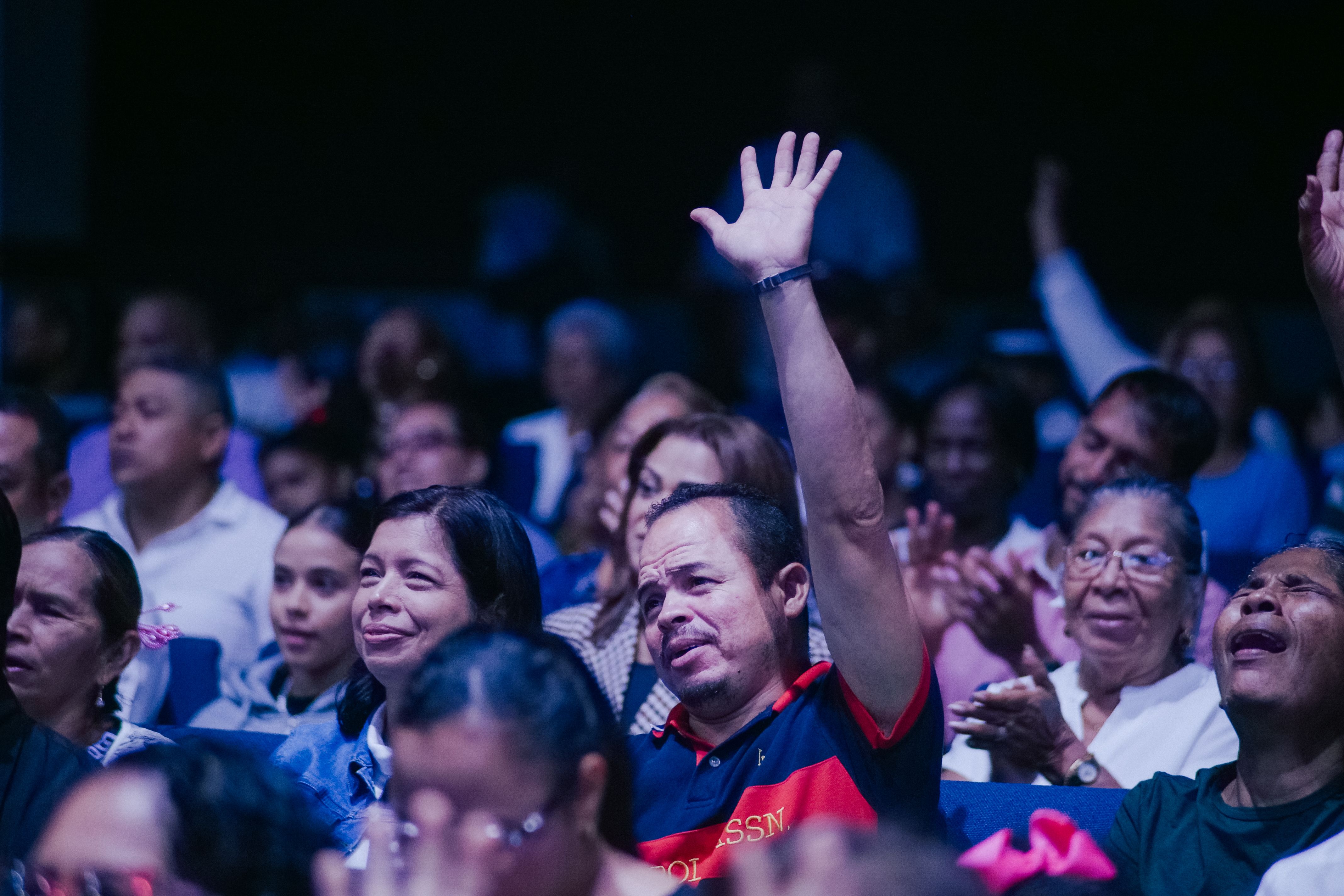 vibrant worship service at Christ Embassy Ho with congregation raising hands