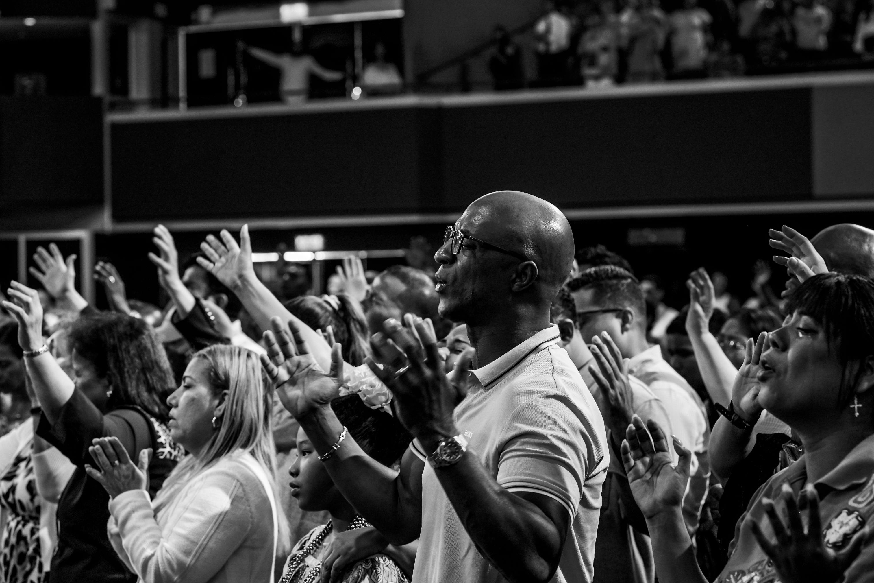 crowd of people at Christ Embassy Loveworld Arena in Ho Ghana with hands raised during worship