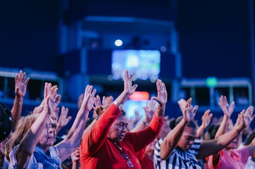 People Praying in Stadium