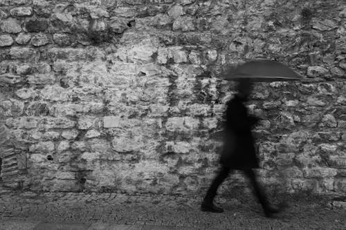 Man Walking with an Umbrella 