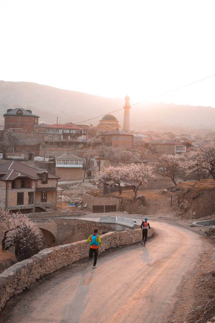 Men Jogging Along Road