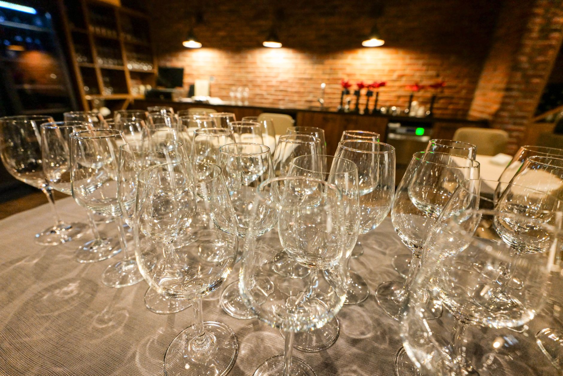 A stylish arrangement of wine glasses in a cozy bistro setting with warm lighting.