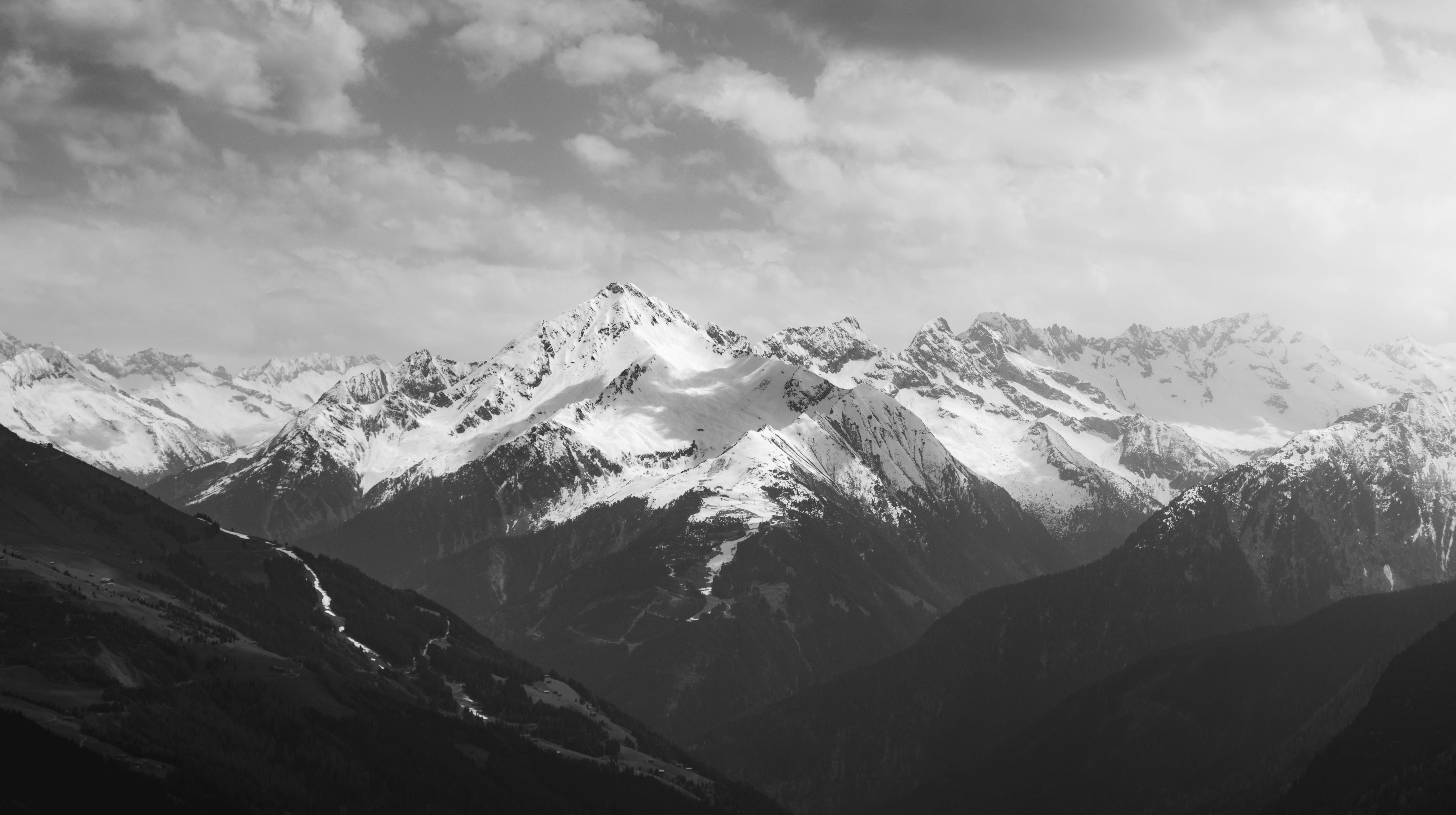 black and white photo of mountains in the snow