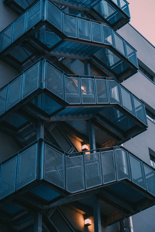 Free Vertical shot of a modern metal staircase on a residential building in Bucharest, Romania. Stock Photo