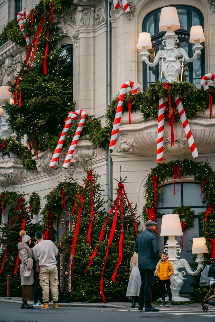 A Facade Of A Building In City Decorated With Christmas Ornaments 