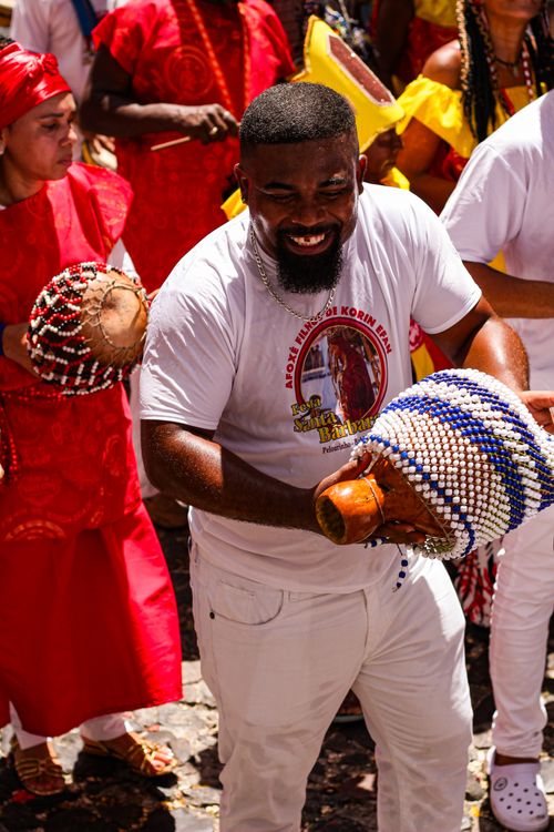 Free Joyful street festival scene with musicians and vibrant costumes playing traditional percussion instruments. Stock Photo
