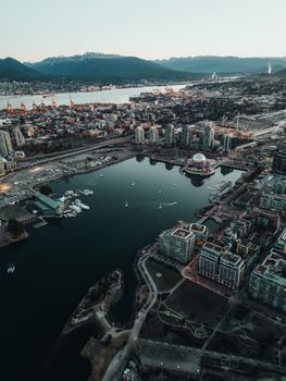 Stunning aerial view of Vancouver's cityscape with modern architecture and harbor at dusk.