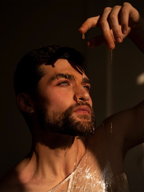Free An artistic portrait of a bearded man illuminated by dramatic, backlit lighting. Stock Photo
