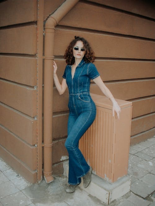 Young Woman in a Denim Jumpsuit Posing Outside 