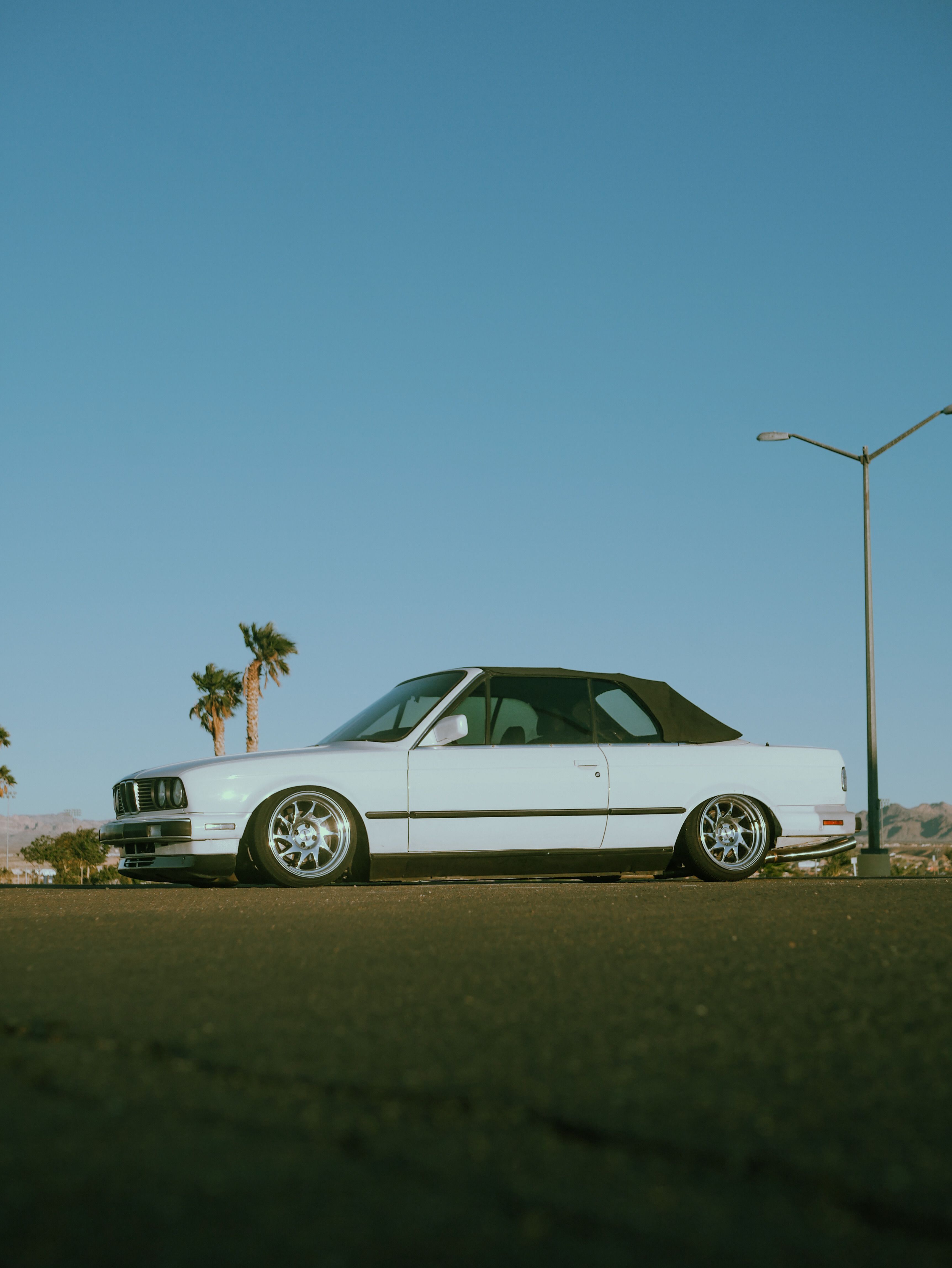 A white car parked on the side of the road · Free Stock Photo