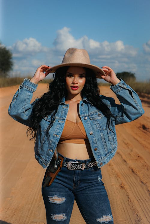 A Woman in Jeans and a Cowboy Hat