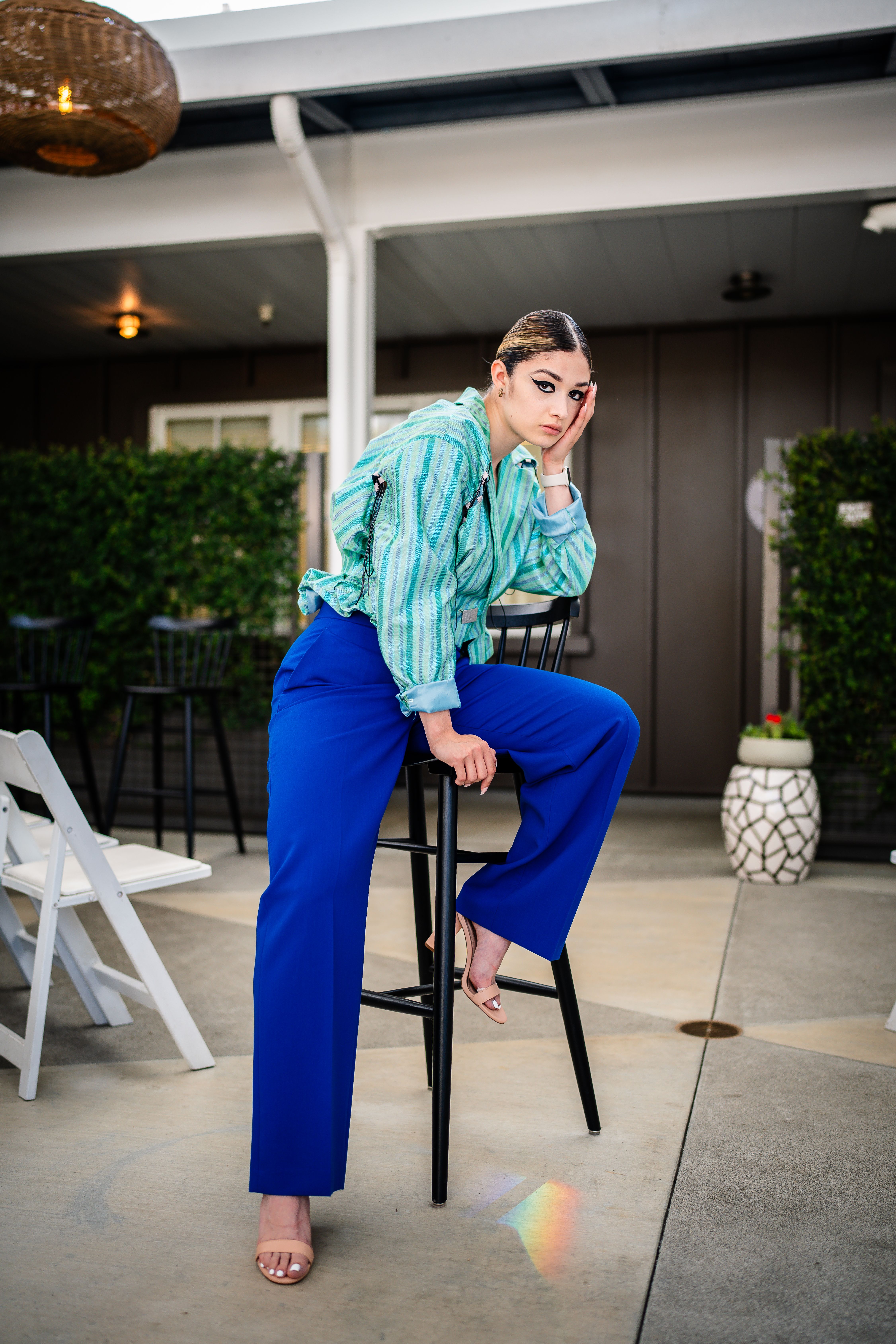 Beautiful Woman in Shirt and Blue Pants Posing on Stool · Free Stock Photo