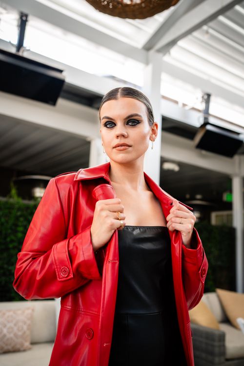 Free Fashionable woman in red coat posing outdoors, embodying modern elegance. Stock Photo